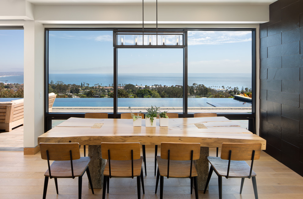 Inspiration for a mid-sized coastal light wood floor and beige floor dining room remodel in San Diego with black walls