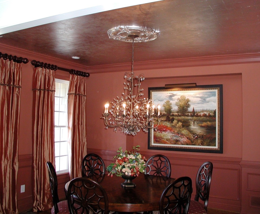Small traditional enclosed dining room in Atlanta with orange walls and medium hardwood flooring.