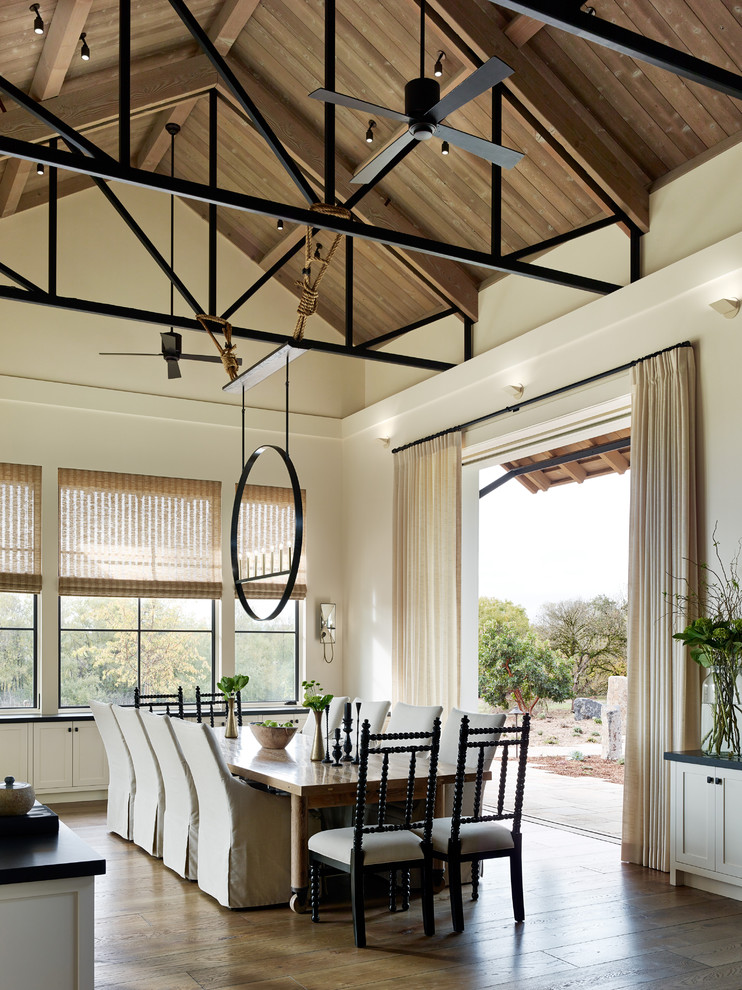 Example of a cottage dark wood floor dining room design in San Francisco with white walls