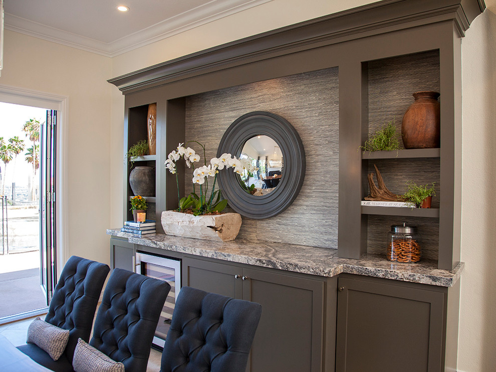 Large traditional kitchen/dining room in Orange County with grey walls and a tiled fireplace surround.