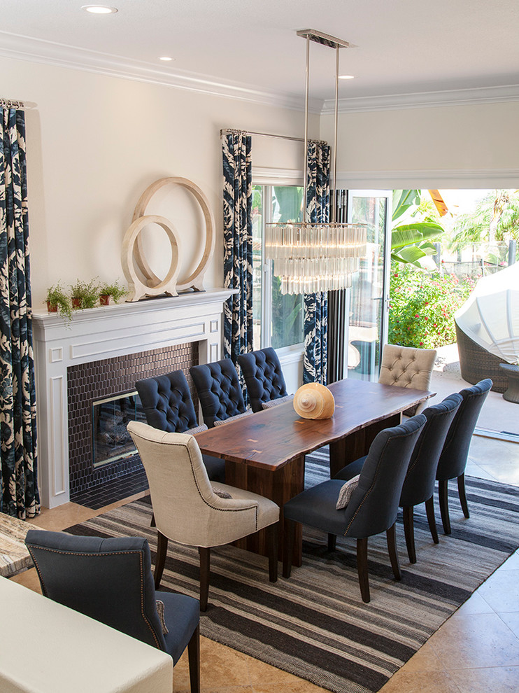 This is an example of a large traditional kitchen/dining room in Orange County with grey walls, limestone flooring and a tiled fireplace surround.