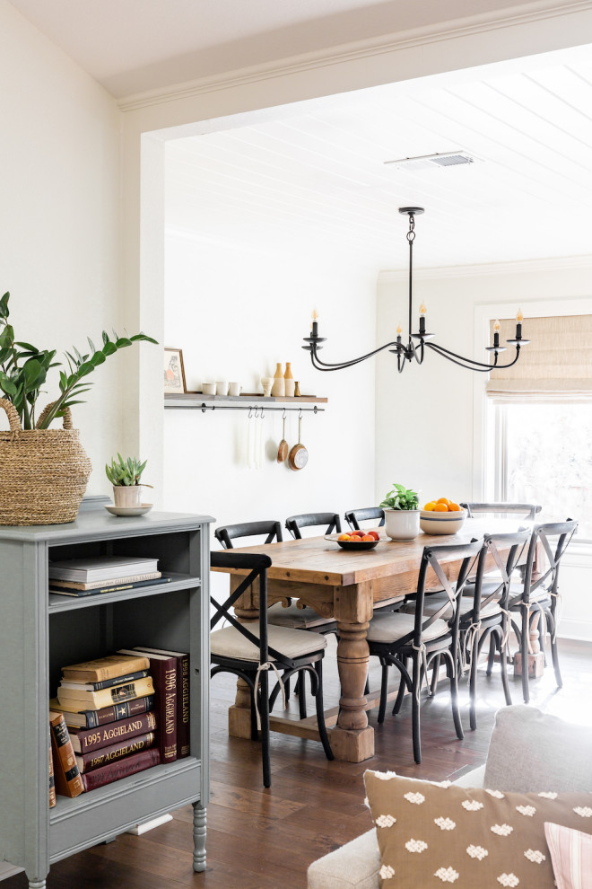 Example of a mid-sized transitional medium tone wood floor and brown floor great room design in Dallas with white walls and no fireplace