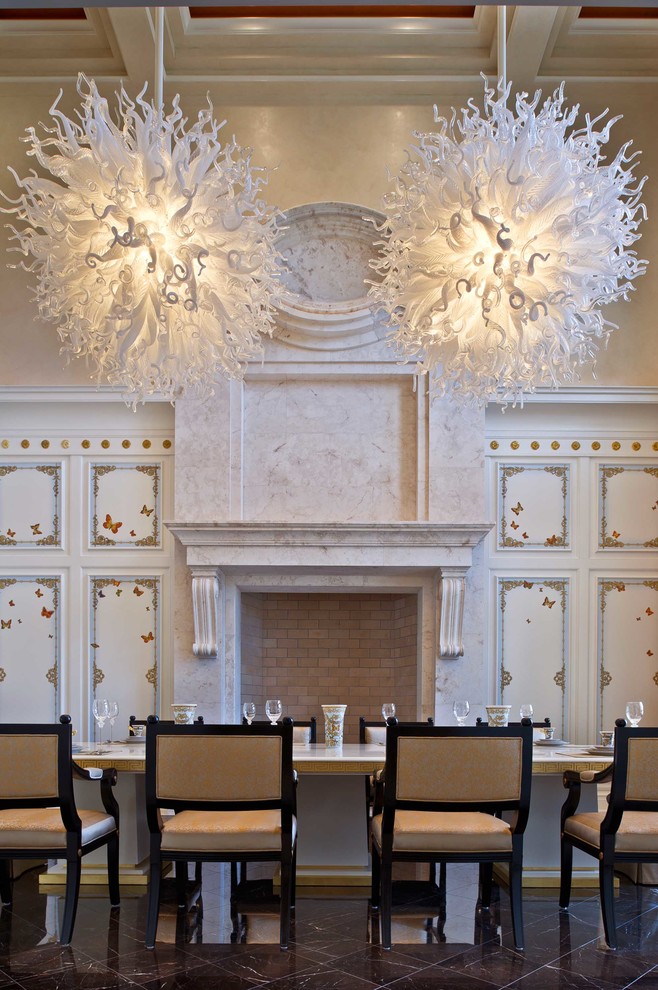 Inspiration for a mediterranean dining room remodel in Orlando with beige walls, a standard fireplace and a stone fireplace