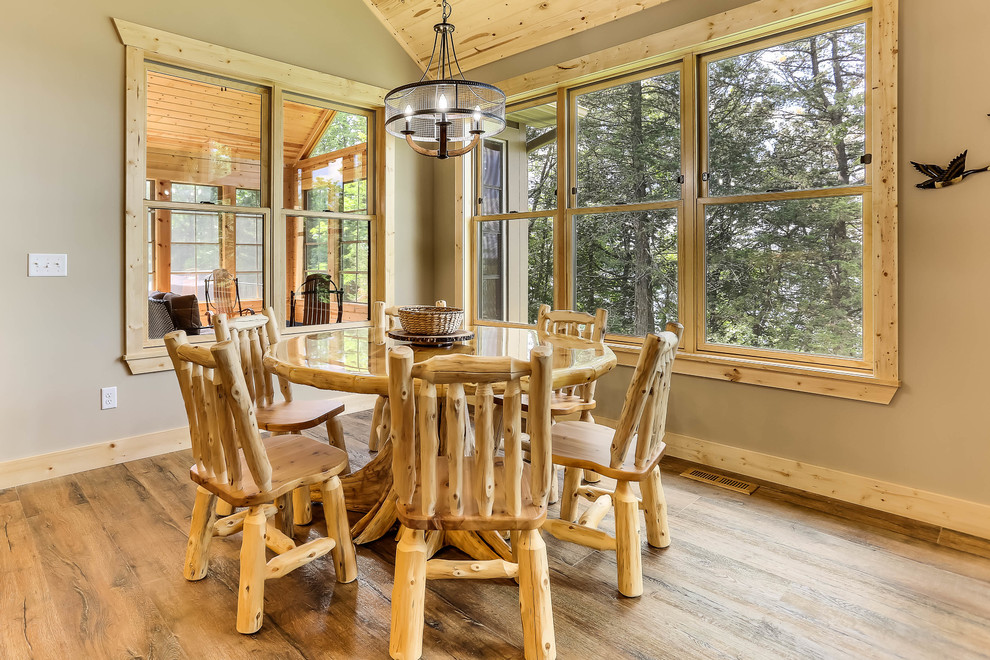 Exemple d'une salle à manger montagne avec un mur beige, un sol en bois brun et aucune cheminée.