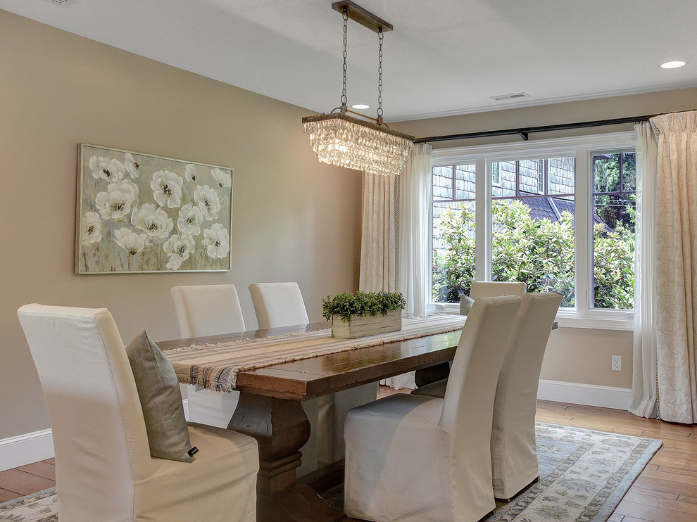 This is an example of a large classic open plan dining room in Portland with beige walls, medium hardwood flooring and no fireplace.