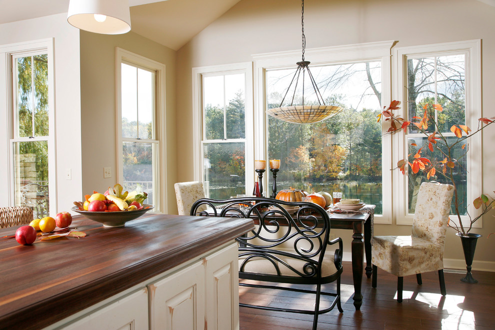 Kitchen/dining room combo - mid-sized traditional dark wood floor and brown floor kitchen/dining room combo idea in Grand Rapids with beige walls and no fireplace