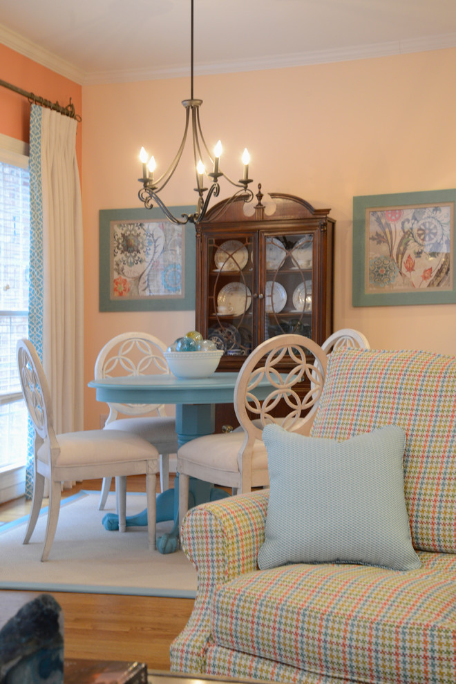 Inspiration pour une petite salle à manger ouverte sur le salon rustique avec un mur orange, parquet clair et aucune cheminée.