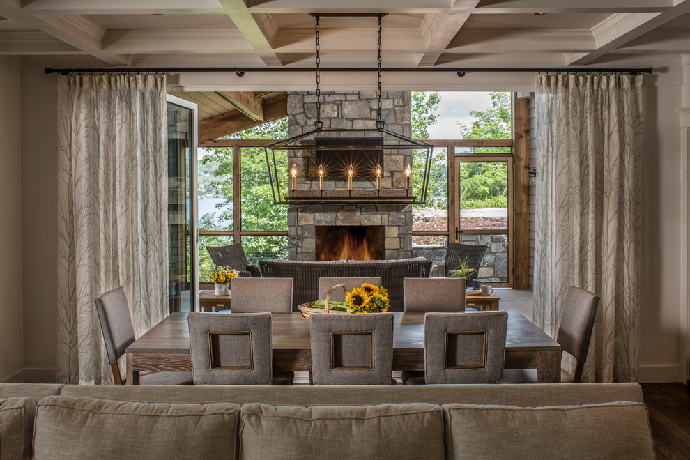 Photo of a large rustic open plan dining room in Other with white walls, dark hardwood flooring, brown floors and a standard fireplace.