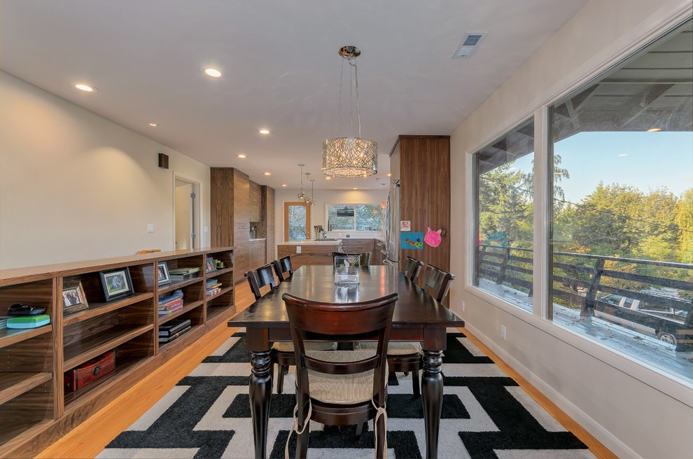 Medium sized contemporary kitchen/dining room in Portland with beige walls, medium hardwood flooring and no fireplace.