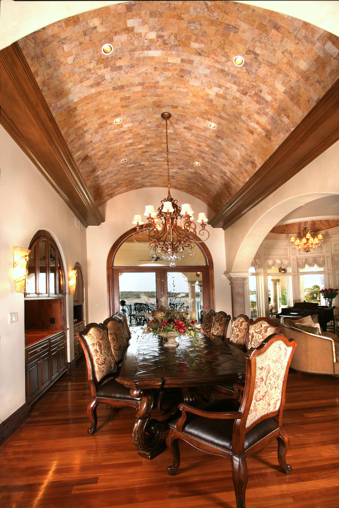 Inspiration for a mediterranean dining room in Austin with beige walls and dark hardwood flooring.