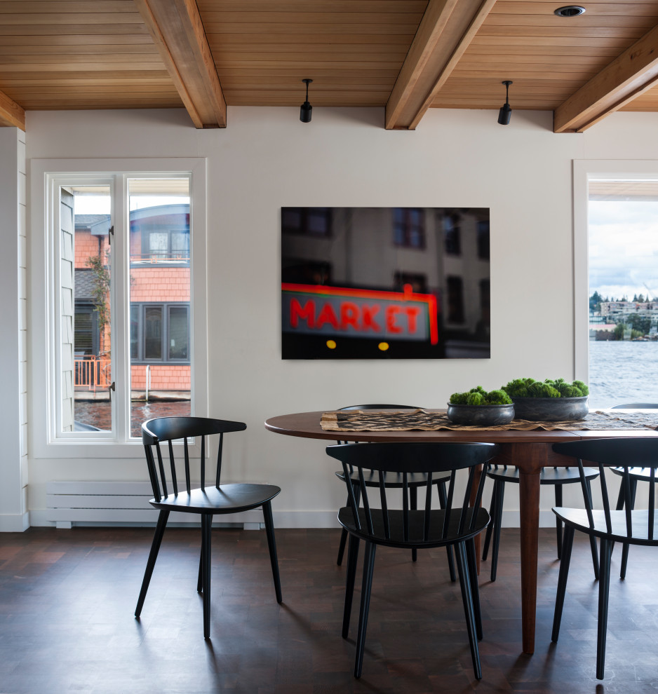 Immagine di una sala da pranzo stile marino con pareti bianche, parquet scuro, pavimento marrone, travi a vista e soffitto in legno