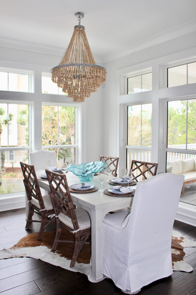 Design ideas for a medium sized beach style dining room in Other with white walls, medium hardwood flooring and brown floors.