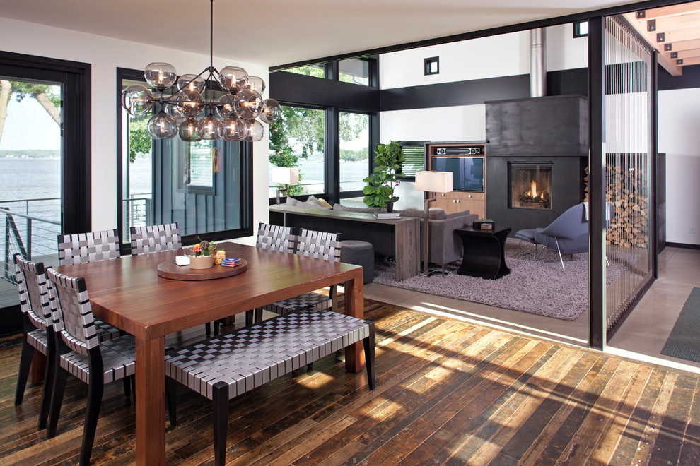 Inspiration for a contemporary medium tone wood floor great room remodel in Minneapolis with white walls