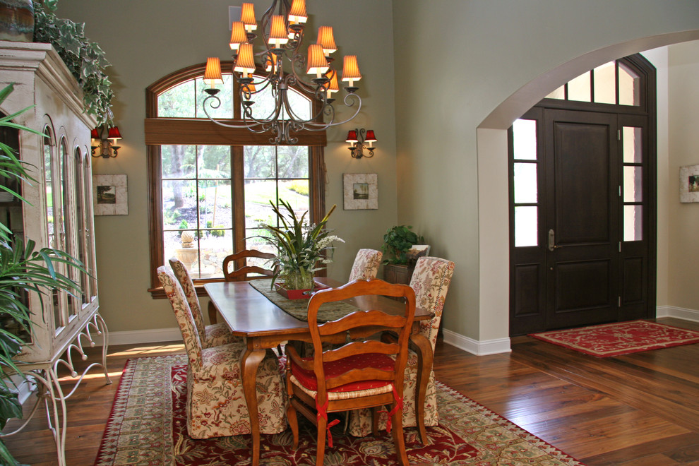 Traditional dining room in Sacramento with green walls and dark hardwood flooring.