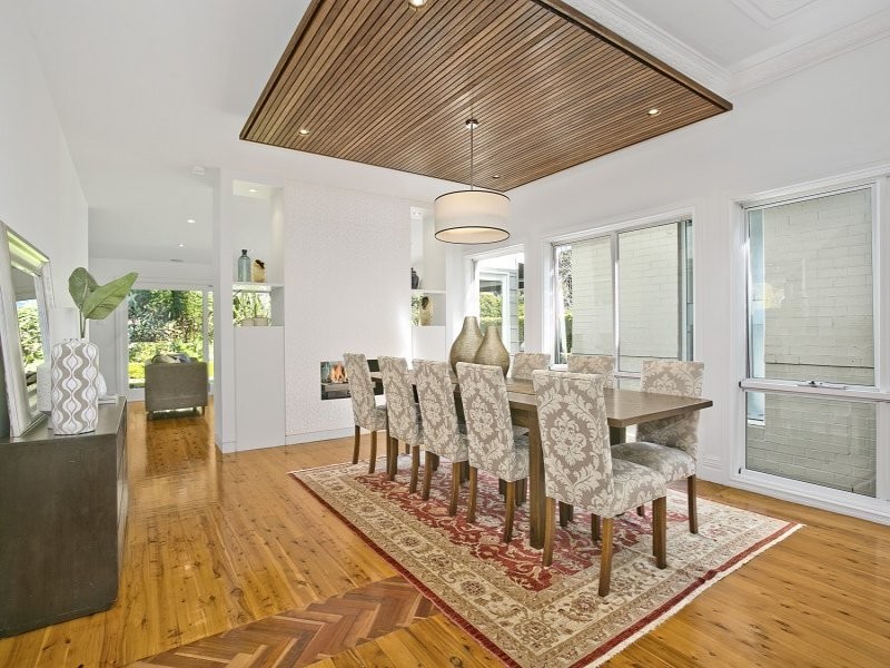 Example of a minimalist dark wood floor dining room design in Sydney