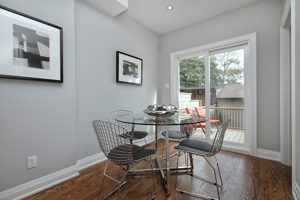 Photo of a large modern kitchen/dining room in Toronto with grey walls and medium hardwood flooring.