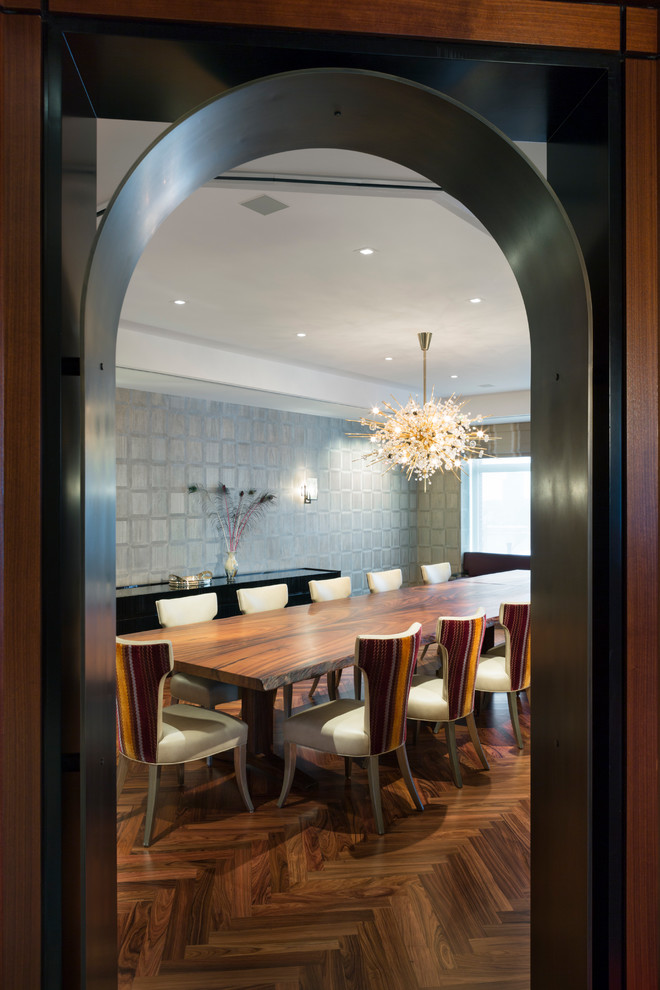 Huge trendy dark wood floor and brown floor enclosed dining room photo in New York with gray walls and no fireplace