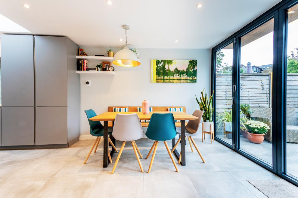 Imagen de comedor de cocina escandinavo con paredes blancas y suelo beige