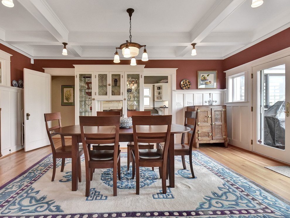 Inspiration for a large craftsman medium tone wood floor and brown floor enclosed dining room remodel in Portland with red walls and no fireplace