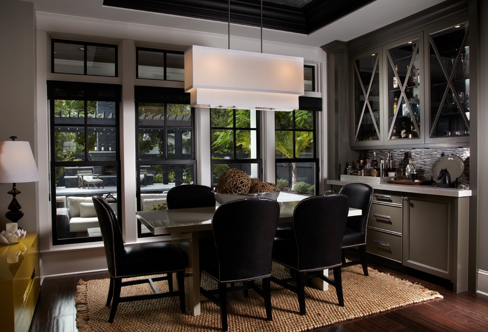 Medium sized contemporary enclosed dining room in Miami with white walls, dark hardwood flooring, no fireplace, brown floors and feature lighting.