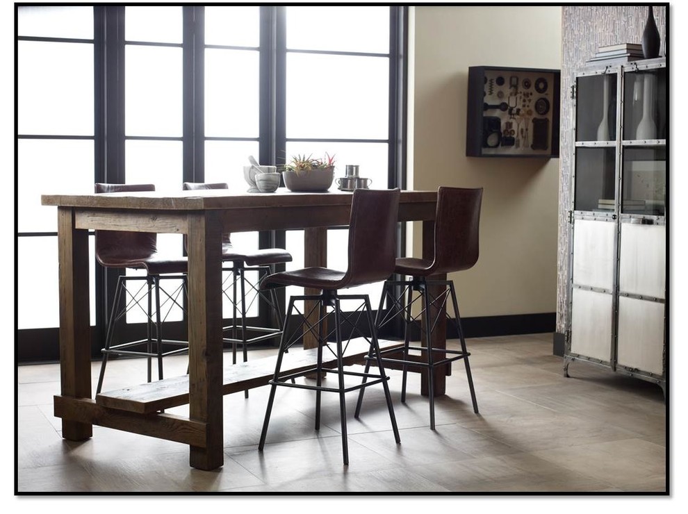 Imagen de comedor de cocina industrial con paredes grises y suelo de cemento