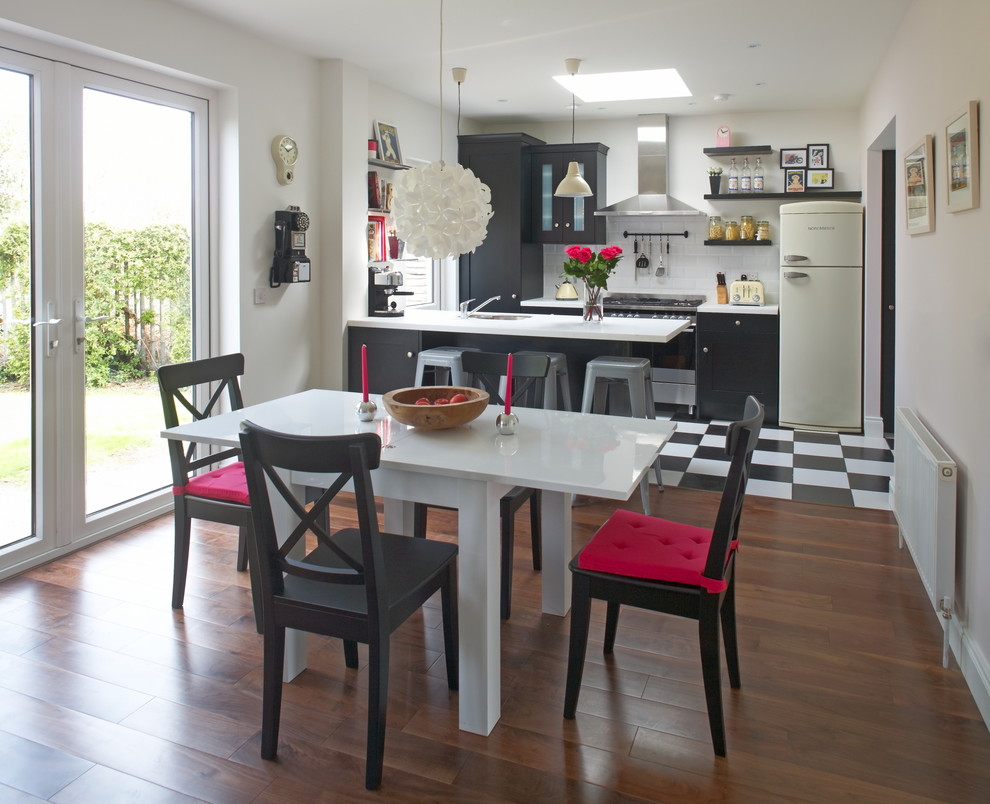 Inspiration for a traditional kitchen/dining room in Dublin with white walls and dark hardwood flooring.