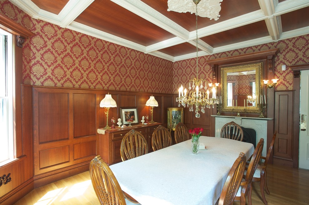 Inspiration for a large traditional enclosed dining room in Boston with multi-coloured walls, light hardwood flooring, a standard fireplace, a stone fireplace surround and brown floors.
