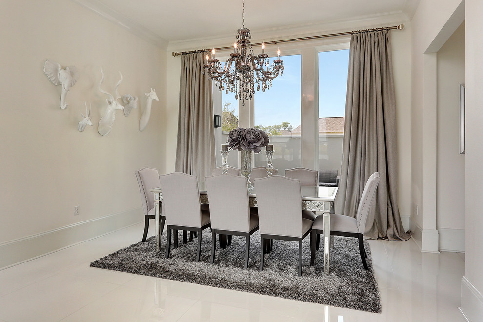 This is an example of a medium sized modern enclosed dining room in New Orleans with beige walls, marble flooring, no fireplace and grey floors.