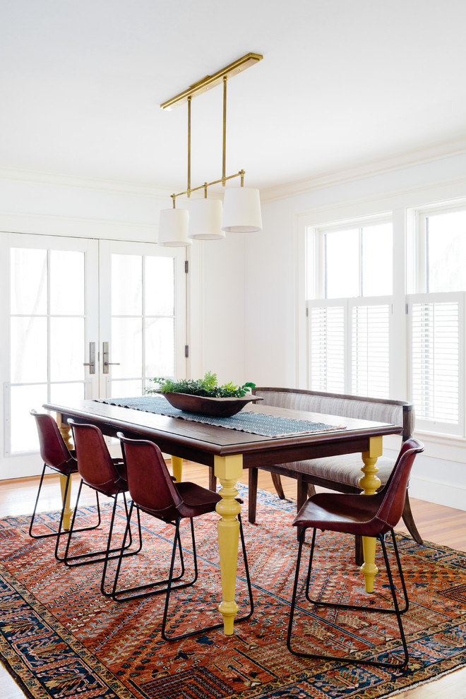 Example of a mid-sized southwest medium tone wood floor and brown floor great room design in Boston with white walls and no fireplace