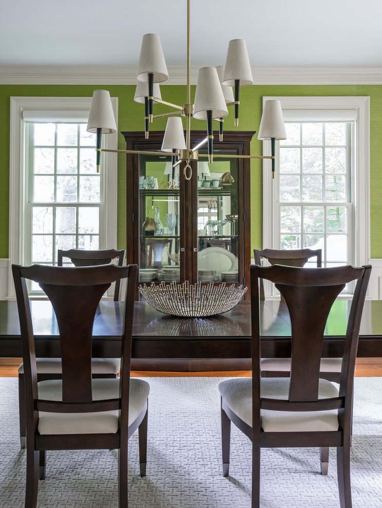 Example of a mid-sized transitional medium tone wood floor enclosed dining room design in Boston with green walls and no fireplace