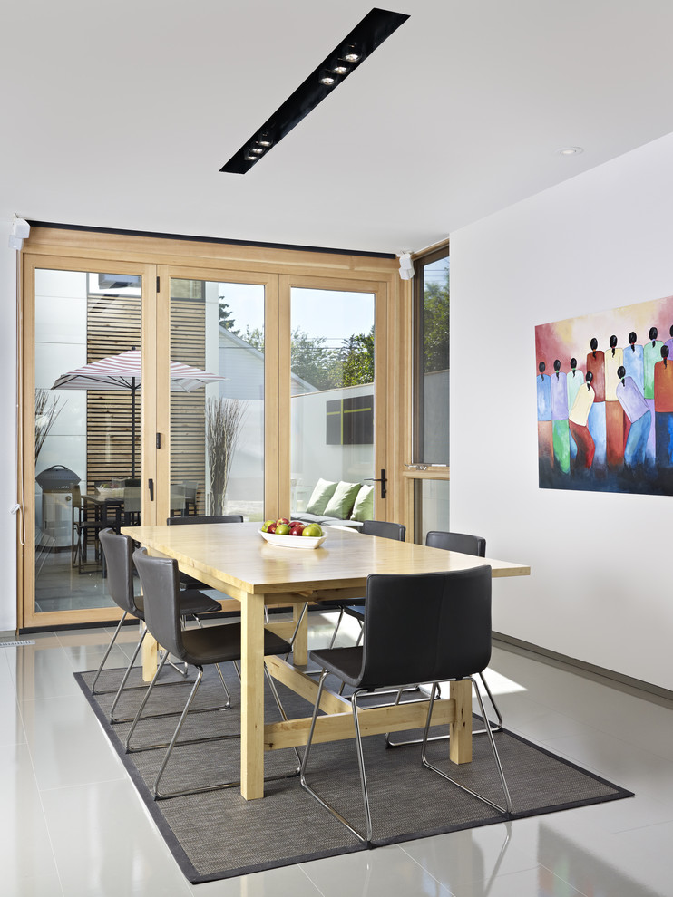 Inspiration for a modern dining room remodel in Edmonton with white walls