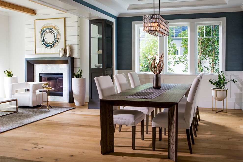 Foto di una sala da pranzo aperta verso il soggiorno classica con pareti blu, pavimento in legno massello medio e pavimento marrone