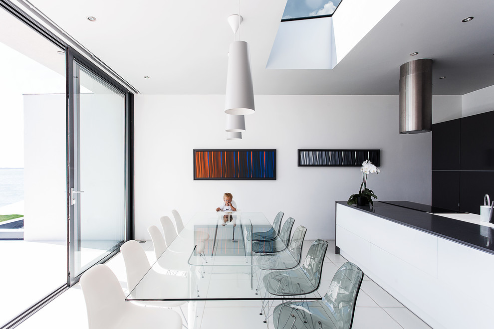 Photo of a contemporary dining room in Hampshire with white walls.