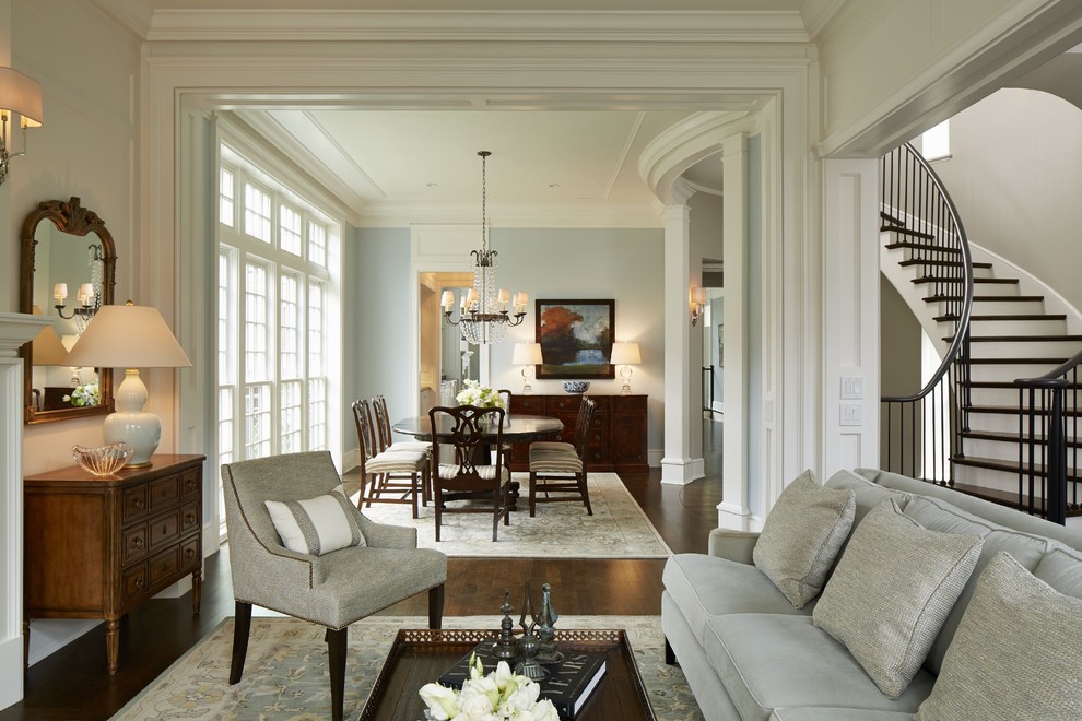 This is an example of a large classic enclosed dining room in Chicago with blue walls, dark hardwood flooring and no fireplace.