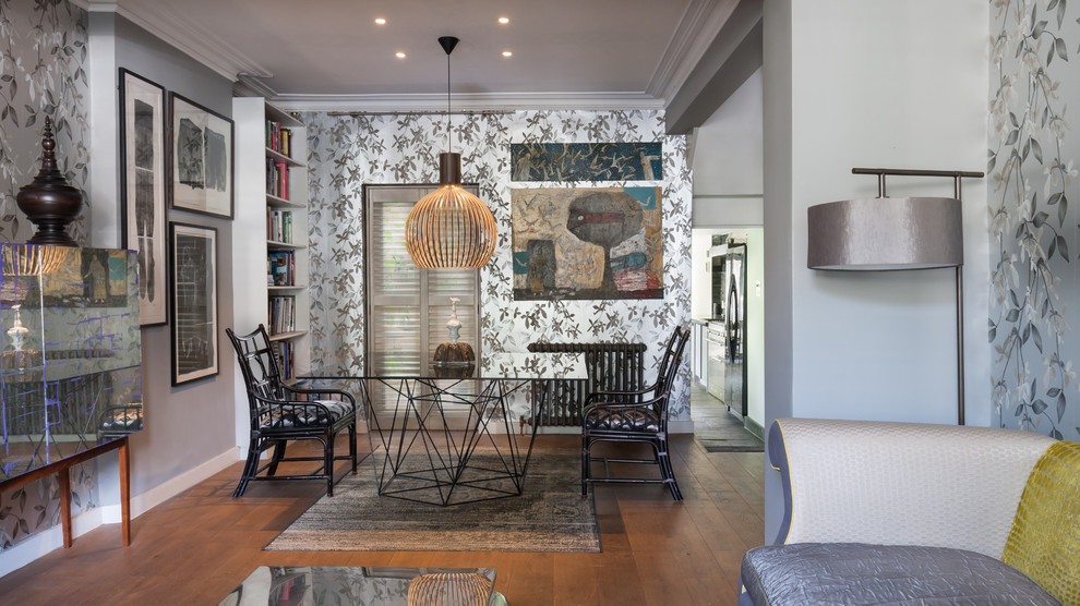 This is an example of a small bohemian dining room in London with brown floors.