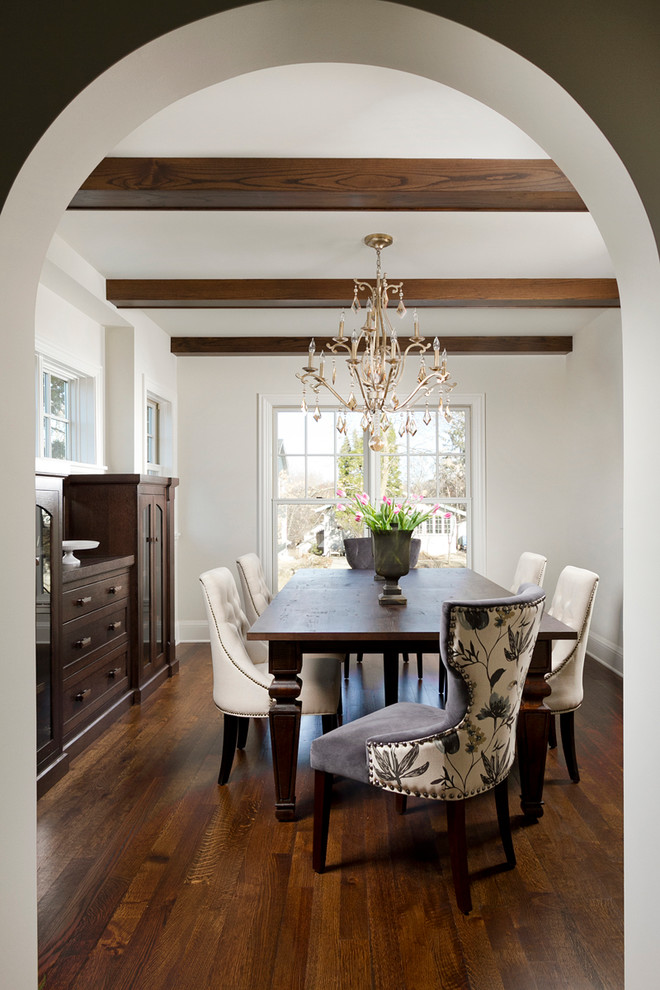 Inspiration for a mediterranean medium tone wood floor enclosed dining room remodel in Minneapolis with white walls