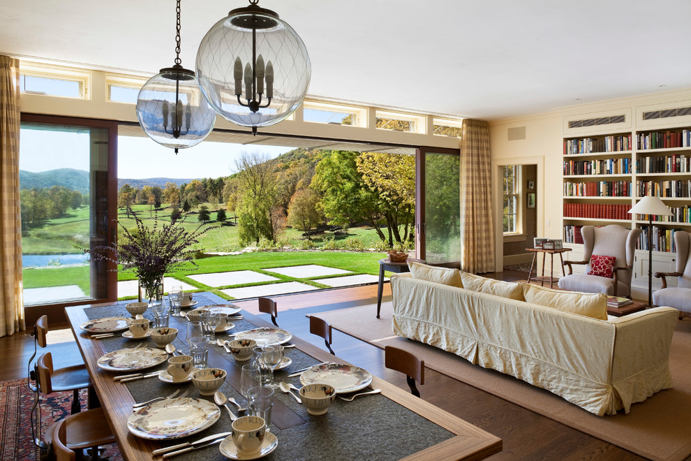 Cette image montre une salle à manger traditionnelle avec un mur beige, parquet foncé et éclairage.