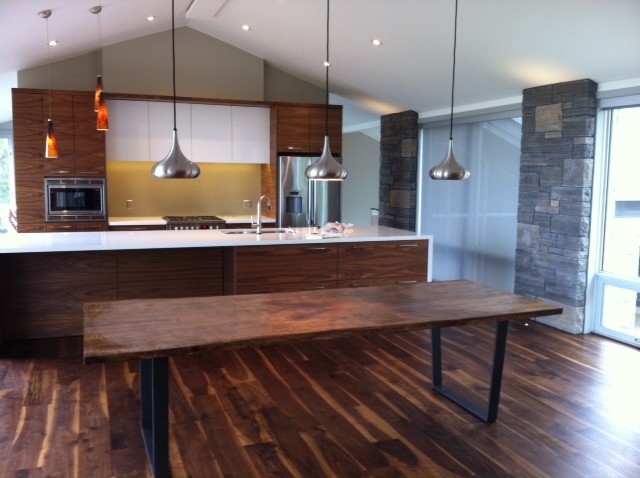 Large classic kitchen/dining room in Toronto with dark hardwood flooring and brown floors.
