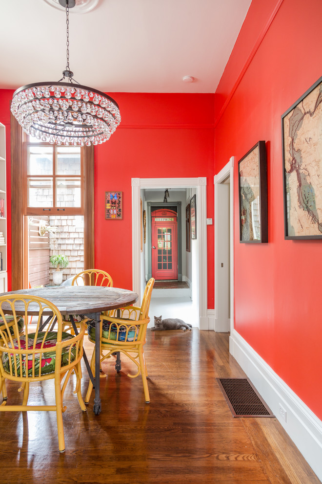 Foto di una sala da pranzo eclettica di medie dimensioni con pareti rosse e pavimento in legno massello medio