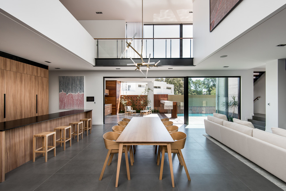 This is an example of an expansive contemporary dining room in Perth with white walls and ceramic flooring.