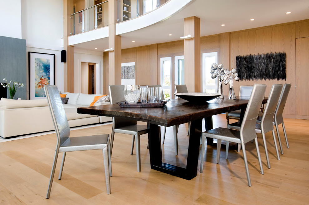 Design ideas for an expansive contemporary open plan dining room in Boston with white walls, light hardwood flooring, a standard fireplace, a concrete fireplace surround and beige floors.