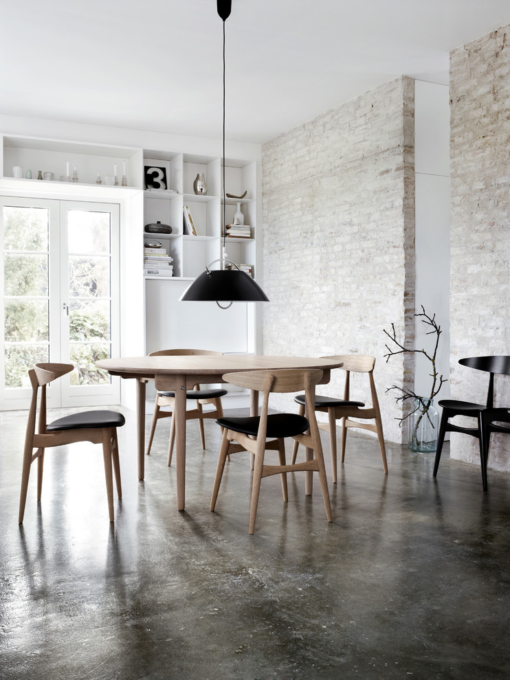 Urban concrete floor dining room photo in New York