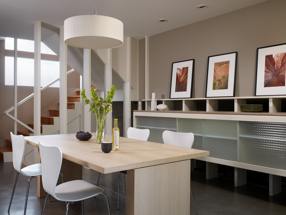 Contemporary dining room in Seattle with brown walls and concrete flooring.