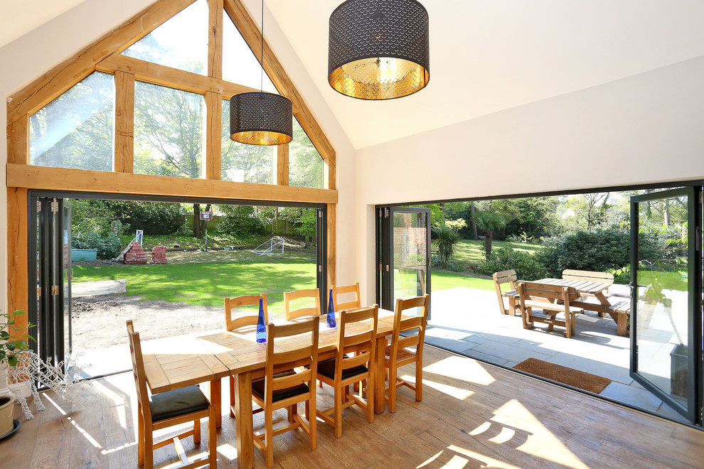 Farmhouse dining room in Berkshire with white walls, medium hardwood flooring and brown floors.