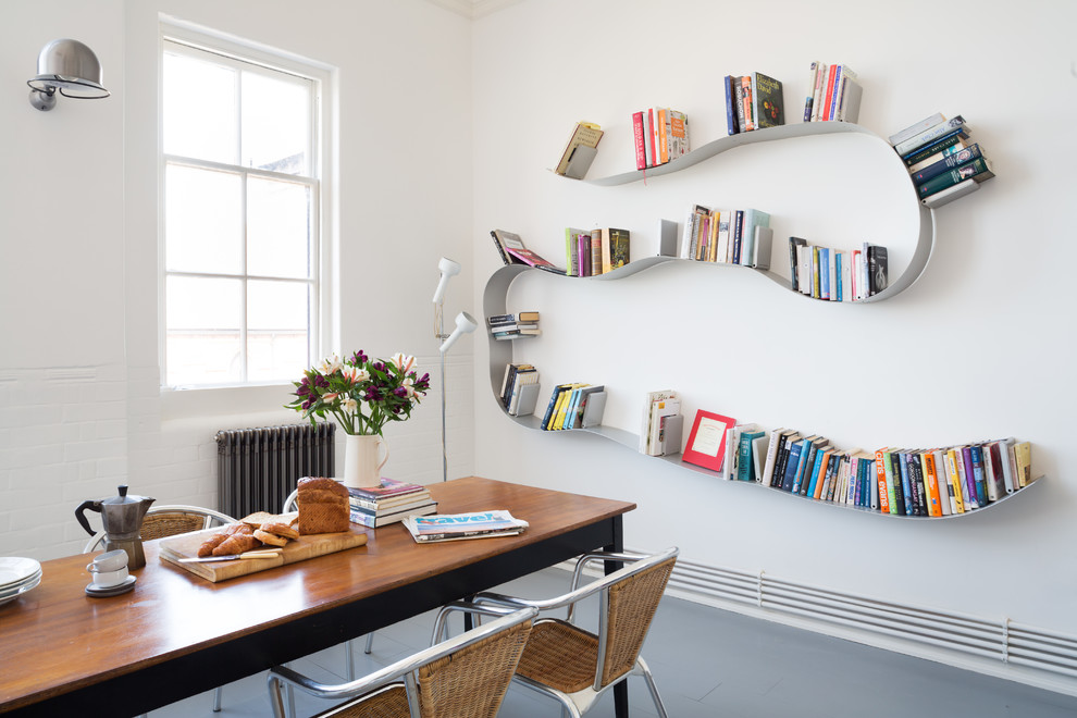 Dining room - large scandinavian painted wood floor dining room idea in London with white walls