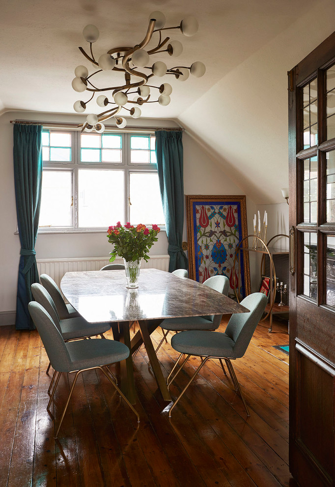 This is an example of a midcentury dining room in London.
