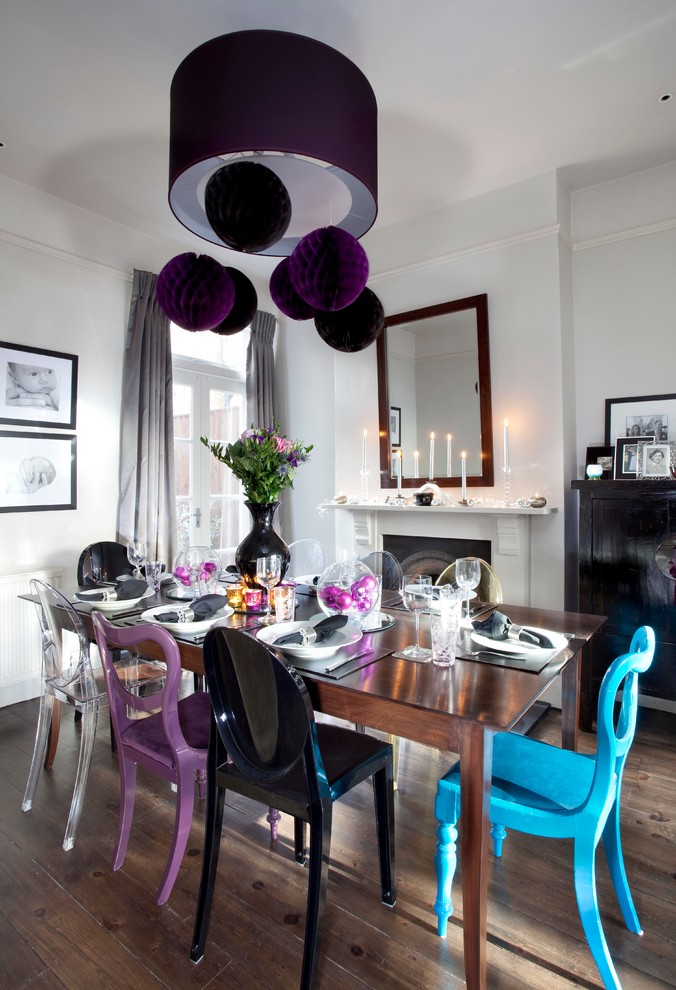 Inspiration for a contemporary dining room in London with white walls, dark hardwood flooring and a standard fireplace.