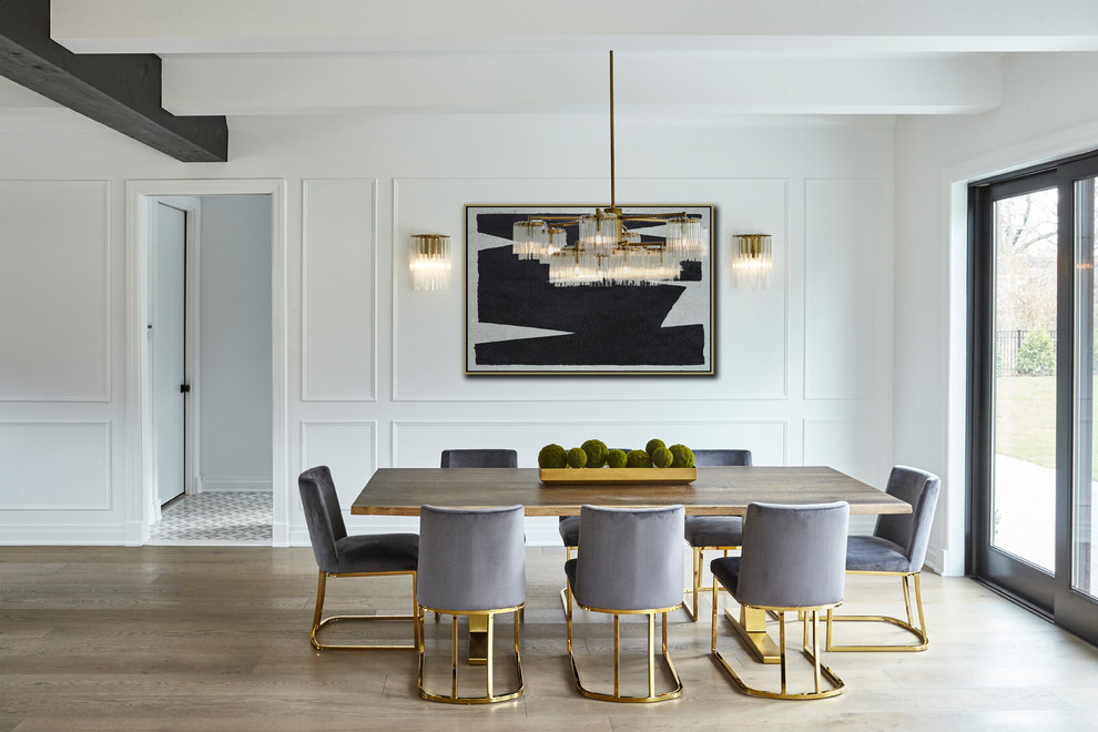 This is an example of a medium sized classic dining room in New York with white walls.