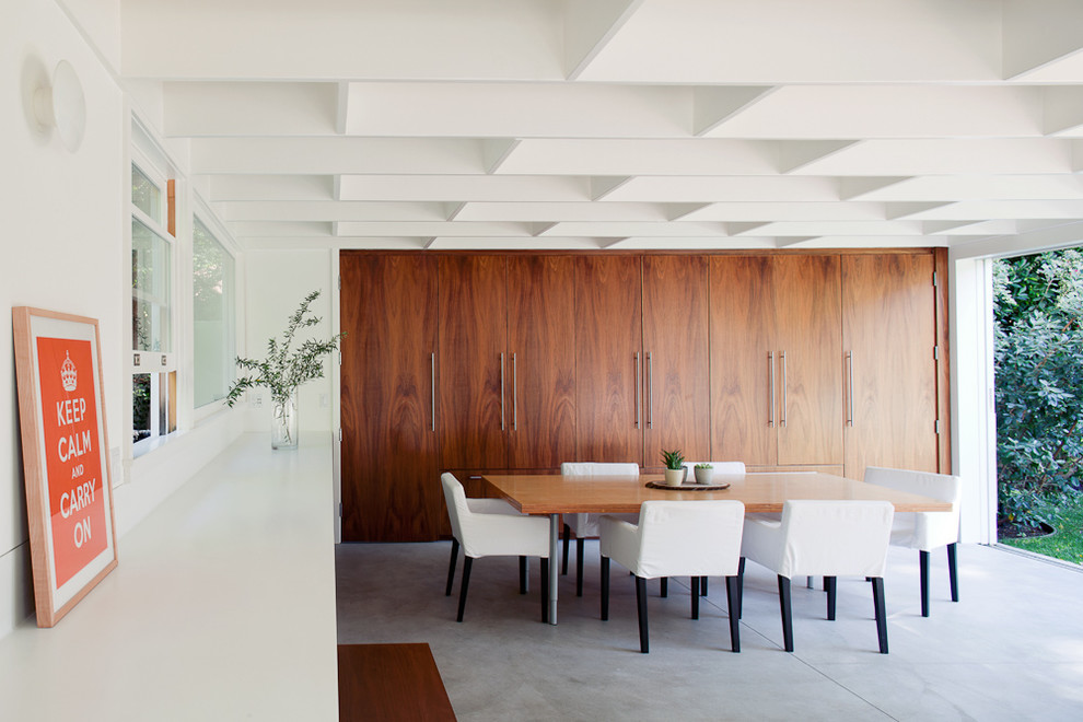 Design ideas for a contemporary dining room in Los Angeles with concrete flooring.
