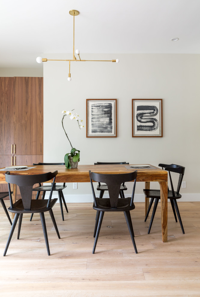 Design ideas for a medium sized contemporary open plan dining room in Los Angeles with beige walls and medium hardwood flooring.